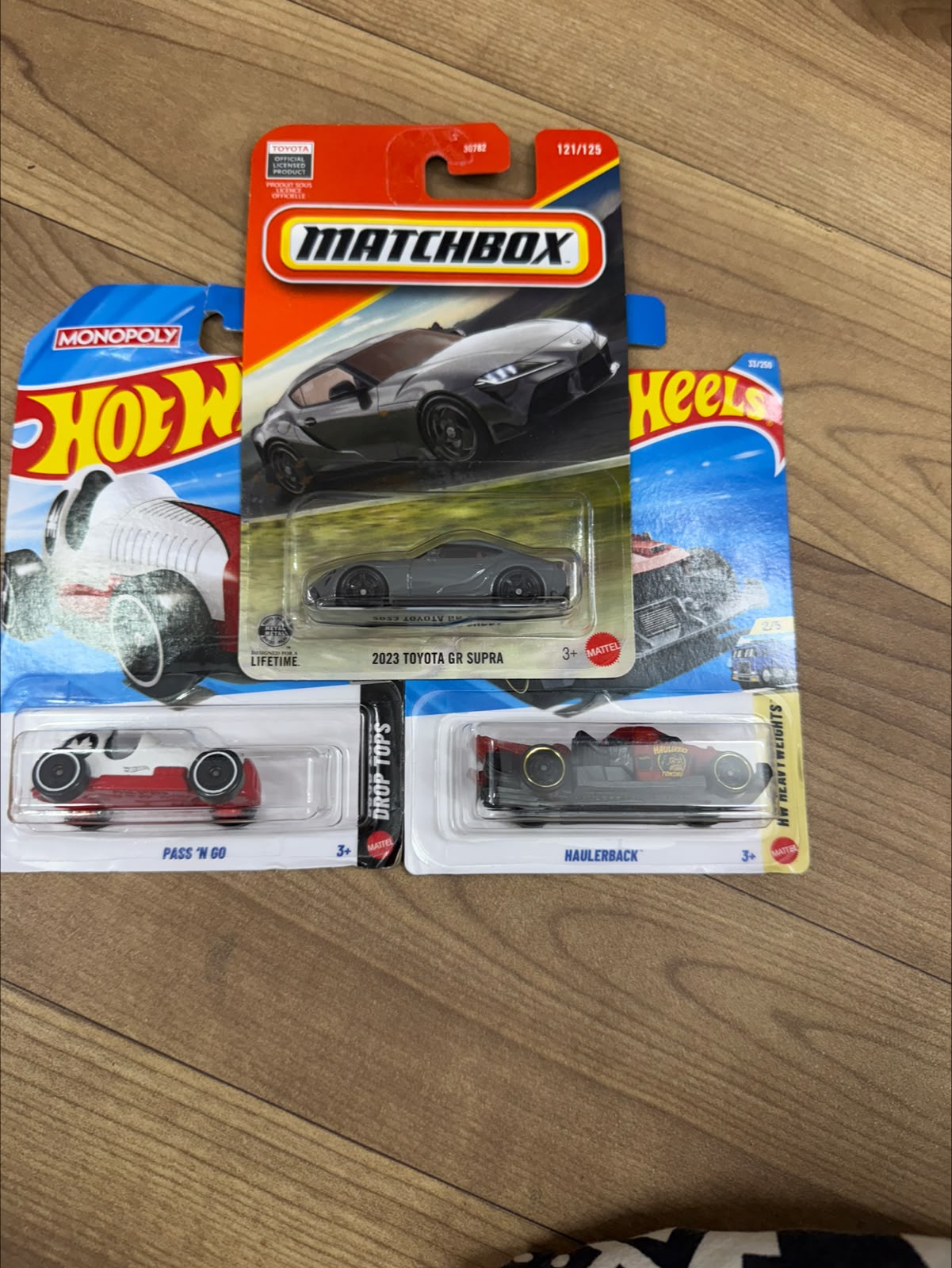 2023 TOYOTA GR SUPRA (MATCHBOX CAR- 30782) AND PASS N GO WHITE (SINGLE HOTWHEELS CAR) AND HAULERBACK (SINGLE HOTWHEELS CAR)