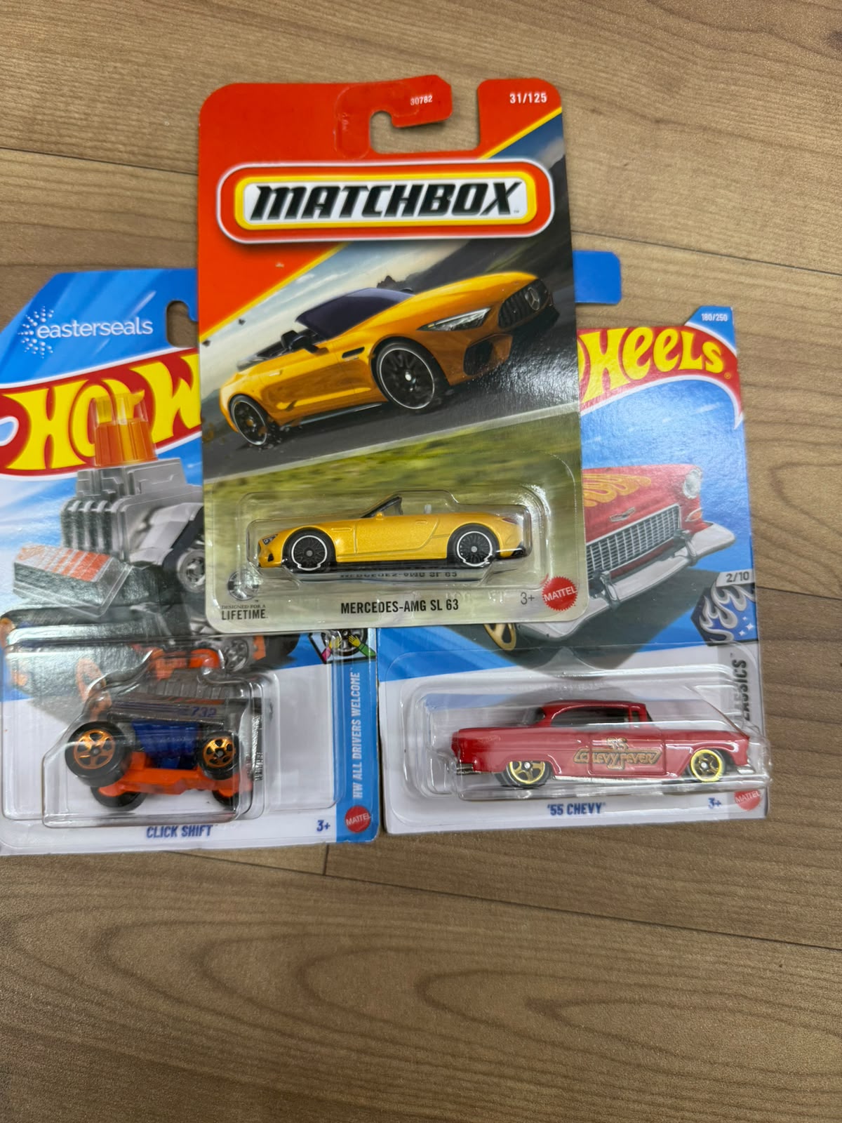 MERCEDES AMG SL 63 (MATCHBOX CAR- 30782) AND 55 CHEVY (SINGLE HOTWHEELS CAR) AND CLICK SHIFT (SINGLE HOTWHEELS CAR)
