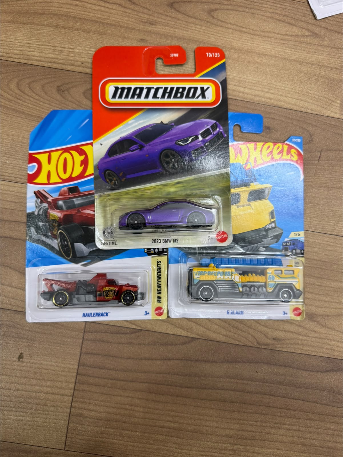 2023 BMW M2 (MATCHBOX CAR- 30782) AND HAULER BACK (SINGLE HOTWHEELS CAR) AND 5 ALARM (SINGLE HOTWHEELS CAR)