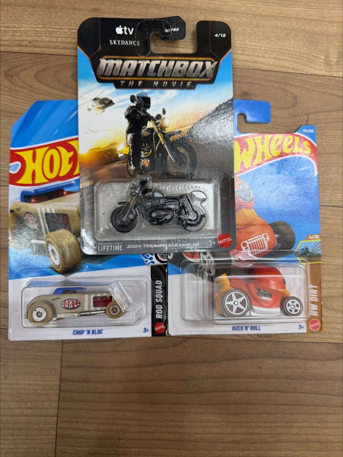 2024 TRIUMPH SCRAMBLER (MATCHBOX CAR- 30782) AND DUCK N ROLL (SINGLE HOTWHEELS CAR) AND CHOP N BLOC (SINGLE HOTWHEELS CAR)